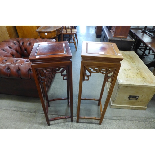 165 - A pair of Chinese hardwood jardiniere stands