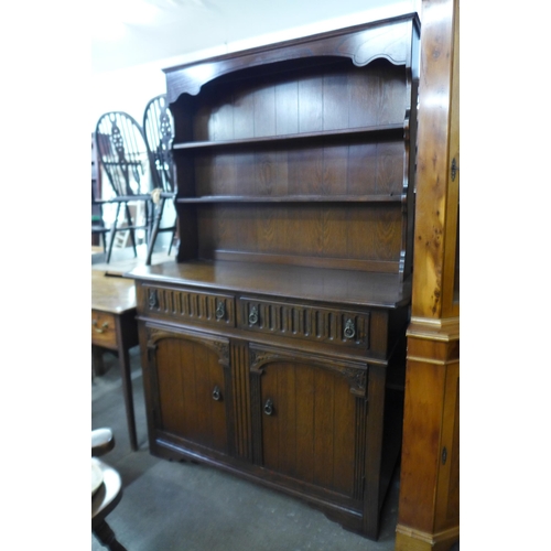 179 - An oak parquetry top refectory table, six beech chairs and an oak dresser