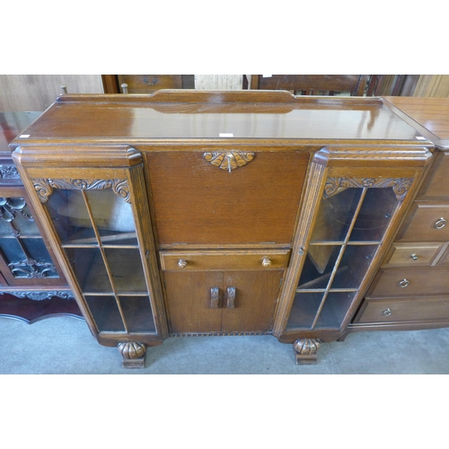 205 - A carved oak side by side bookcase