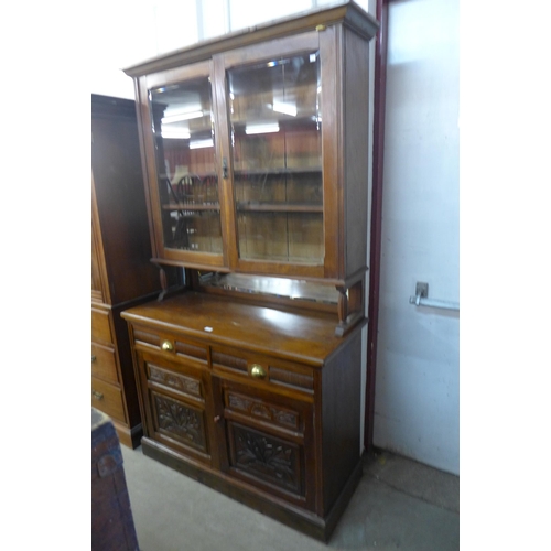 231 - A Victorian Aesthetic Movement carved walnut bookcase