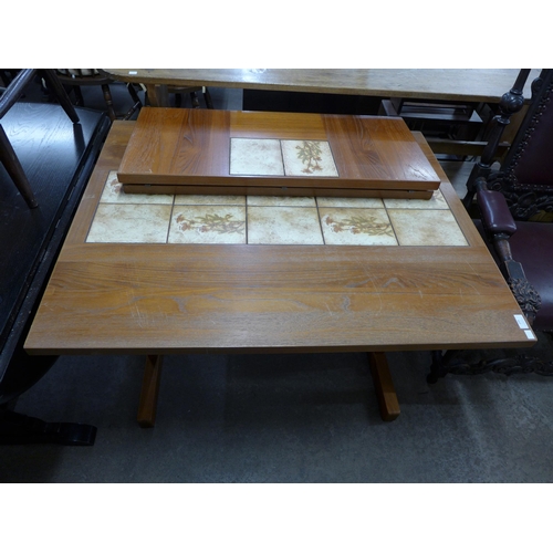 239 - A Danish teak and tiled top extending dining table