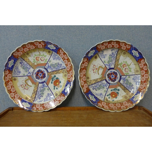 377 - A pair of Japanese Imari pattern porcelain chargers