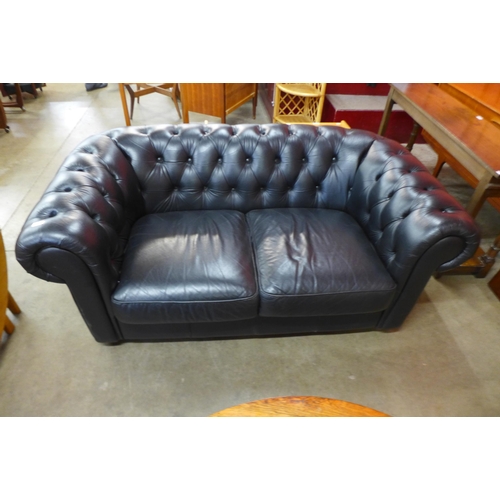 88 - A black leather Chesterfield settee