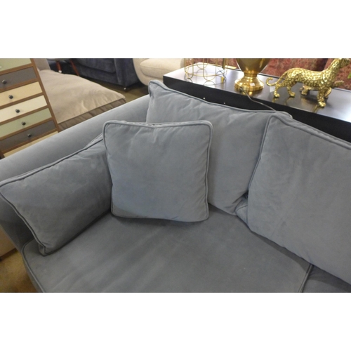 1305 - A steel blue velvet three seater sofa