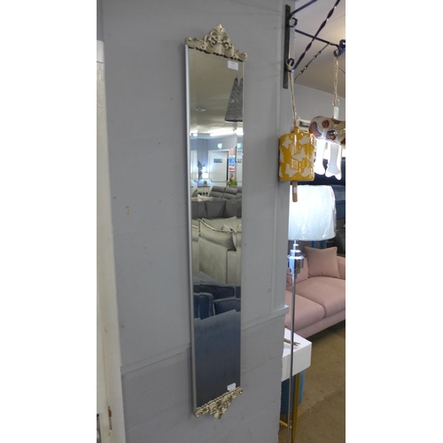 1306 - A bevelled edge wall mirror (136 x 22cm)