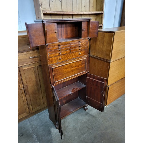 174 - A vintage stained softwood dentist cabinet