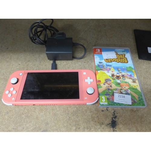 2218 - Nintendo Switch lite-  coral pink with charger and 2 games - W