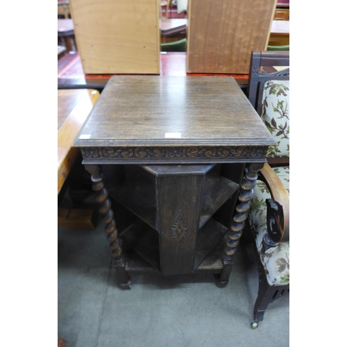 101 - An early 20th Century carved oak barleytwist revolving bookcase