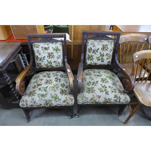 102 - A pair of Victorian Aesthetic Movement mahogany and fabric upholstered library chairs