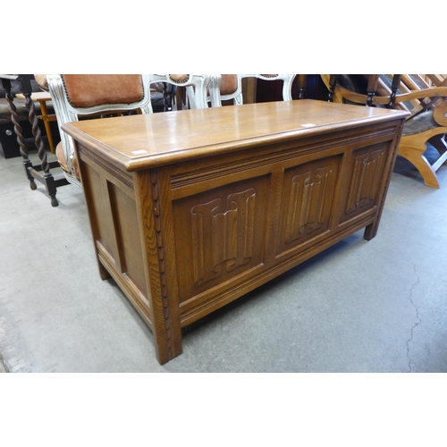 108 - A carved oak linenfold blanket box