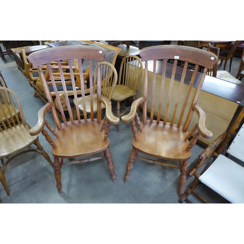 114 - A pair of beech farmhouse armchairs