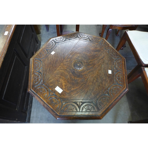 121 - An early 20th Century carved oak octagonal occasional table