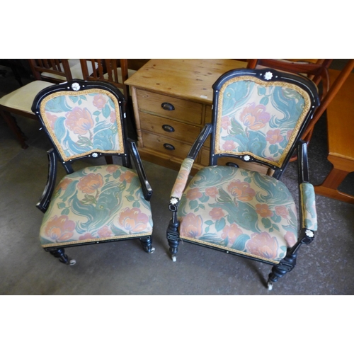 125 - A pair of Victorian Aesthetic Movement ebonised and fabric upholstered chairs