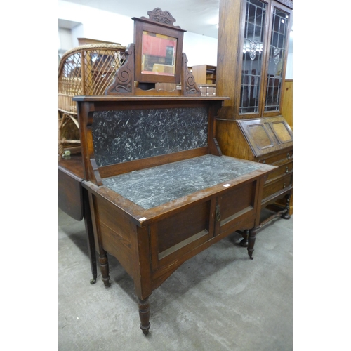 145 - A Victorian oak and marble topped washstand