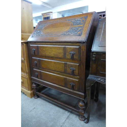 149 - A carved oak bureau