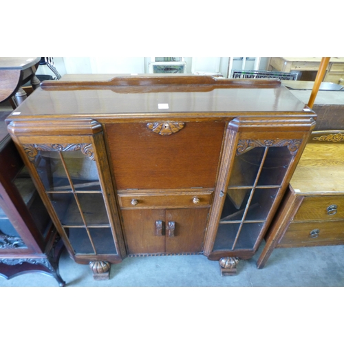 188 - A carved oak side by side bookcase