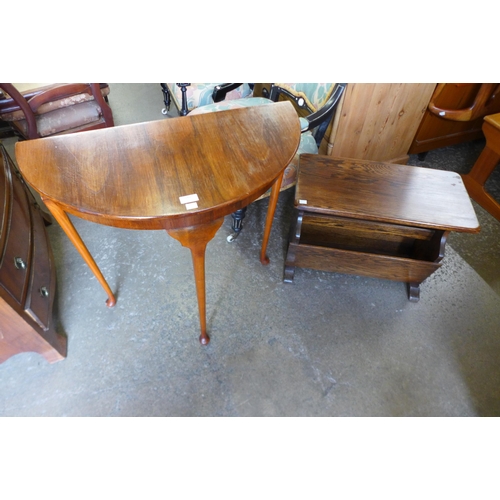 189 - An oak magazine rack and a walnut demi-lune hall table