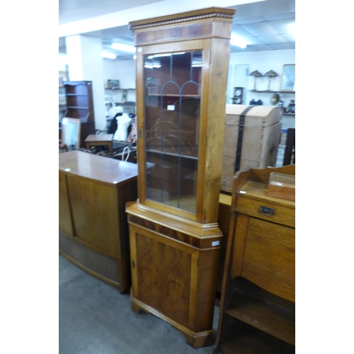 197 - A yew wood freestanding corner cabinet