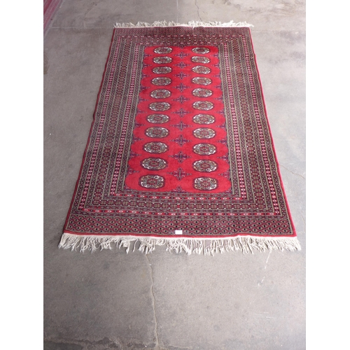 205 - An eastern red ground rug