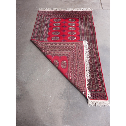 205 - An eastern red ground rug