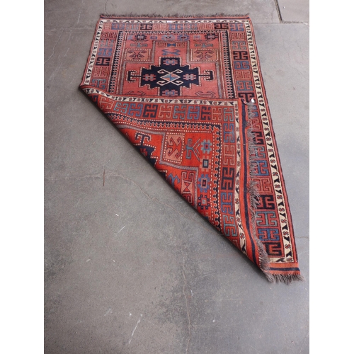 208 - An eastern red ground rug