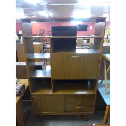 211 - A Danish teak and tiled top extending dining table and a simulated teak room divider