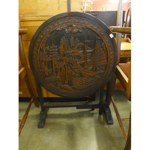 215 - A Chinese carved wooden folding occasional table/firescreen and a pair of Queen Anne style mahogany ... 