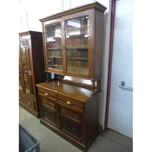 218 - A Victorian Aesthetic Movement carved walnut bookcase