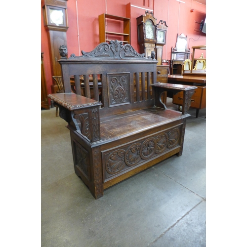 25 - An early 20th Century Jacobean Revival carved oak settle