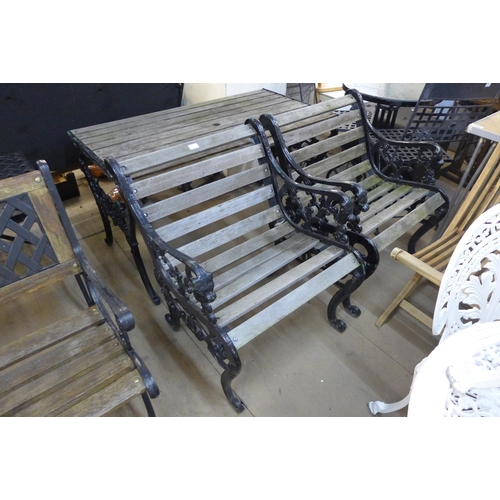 290 - A cast iron garden table and two chairs