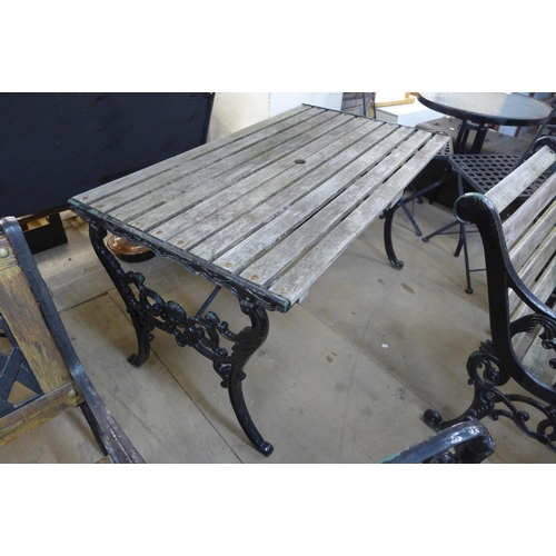 290 - A cast iron garden table and two chairs