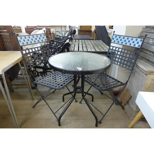 296 - A small black metal and glass topped garden table and two chairs