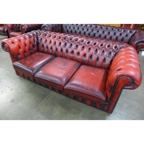 3 - A red leather Chesterfield settee