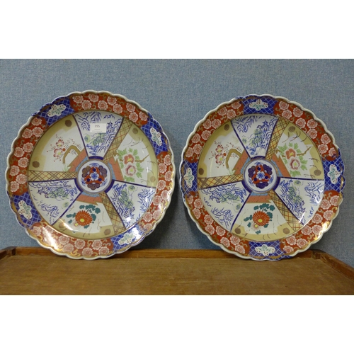 355 - A pair of Japanese Imari pattern porcelain chargers