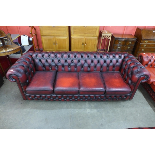 4 - A red leather Chesterfield settee