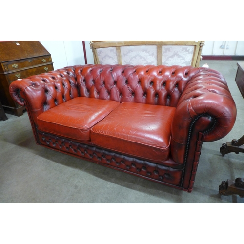 5 - A red leather Chesterfield settee