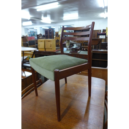 54 - An Austin Suite teak extending dining table and four chairs