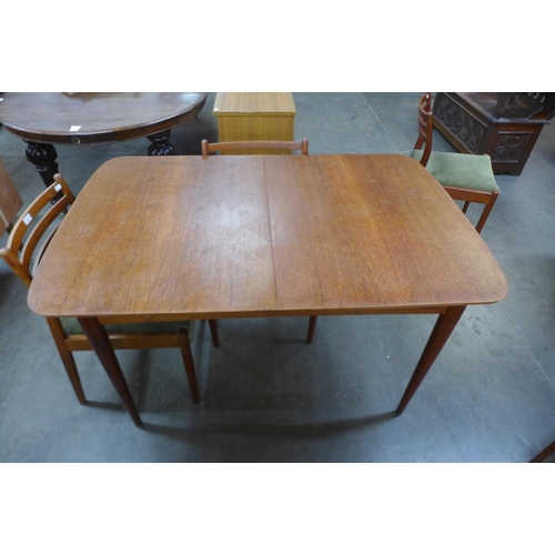 54 - An Austin Suite teak extending dining table and four chairs