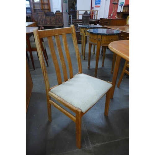 63 - A Danish teak extending dining table and four chairs