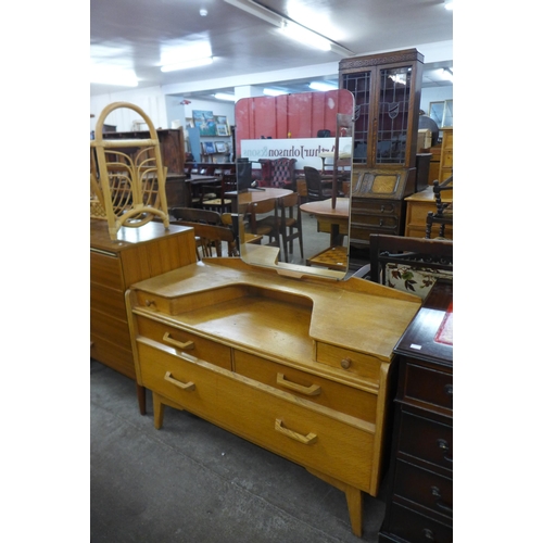 69 - A pair of G-Plan Brandon light oak bedside cabinets and a dressing table