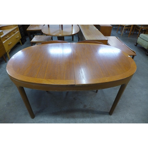 73 - A Nathan teak extending dining table and four chairs