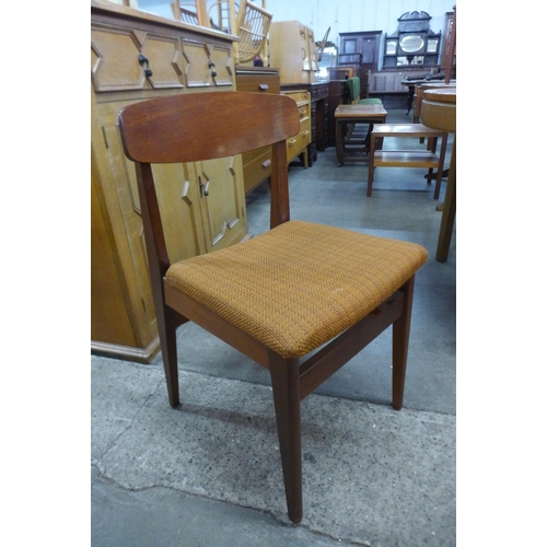 73 - A Nathan teak extending dining table and four chairs