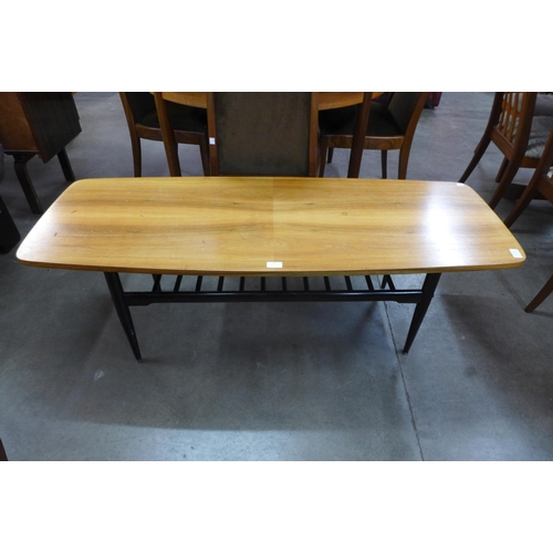 77 - A walnut and ebonised coffee table