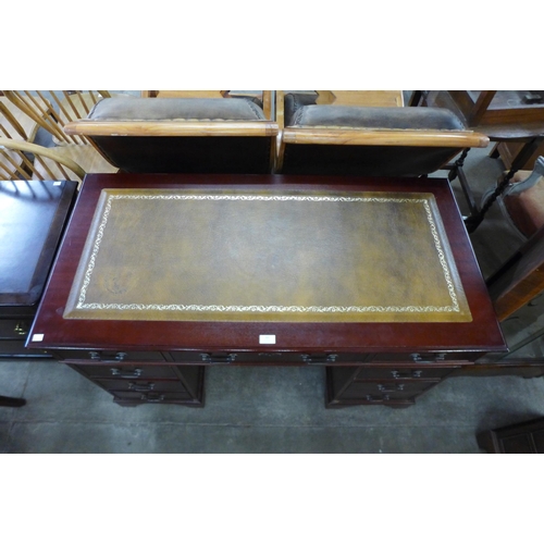 83 - A mahogany and green leather topped pedestal desk