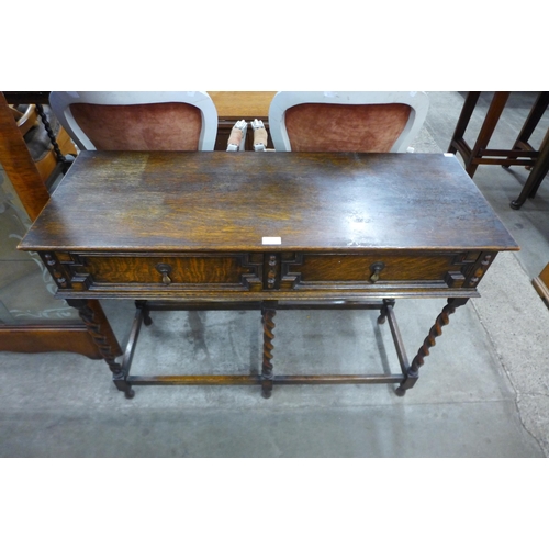 86 - An early 20th Century Jacobean Revival oak barleytwist two drawer serving table