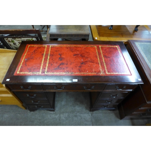 88 - A mahogany and red leather topped pedestal desk