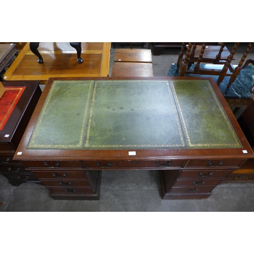 89 - A mahogany and green leather topped pedestal desk