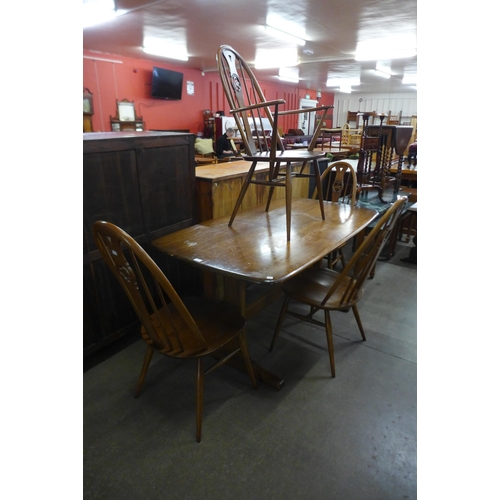 93 - An Ercol Golden Dawn elm and beech refectory table and four chairs