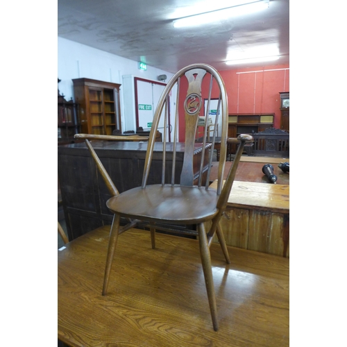 93 - An Ercol Golden Dawn elm and beech refectory table and four chairs