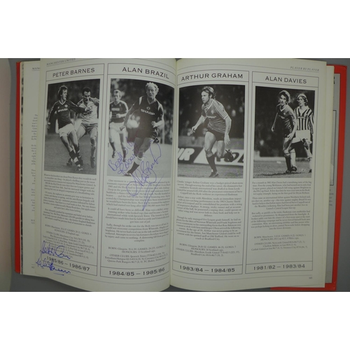 702 - Manchester United; a player by player book containing approximately 97 signatures from former player... 